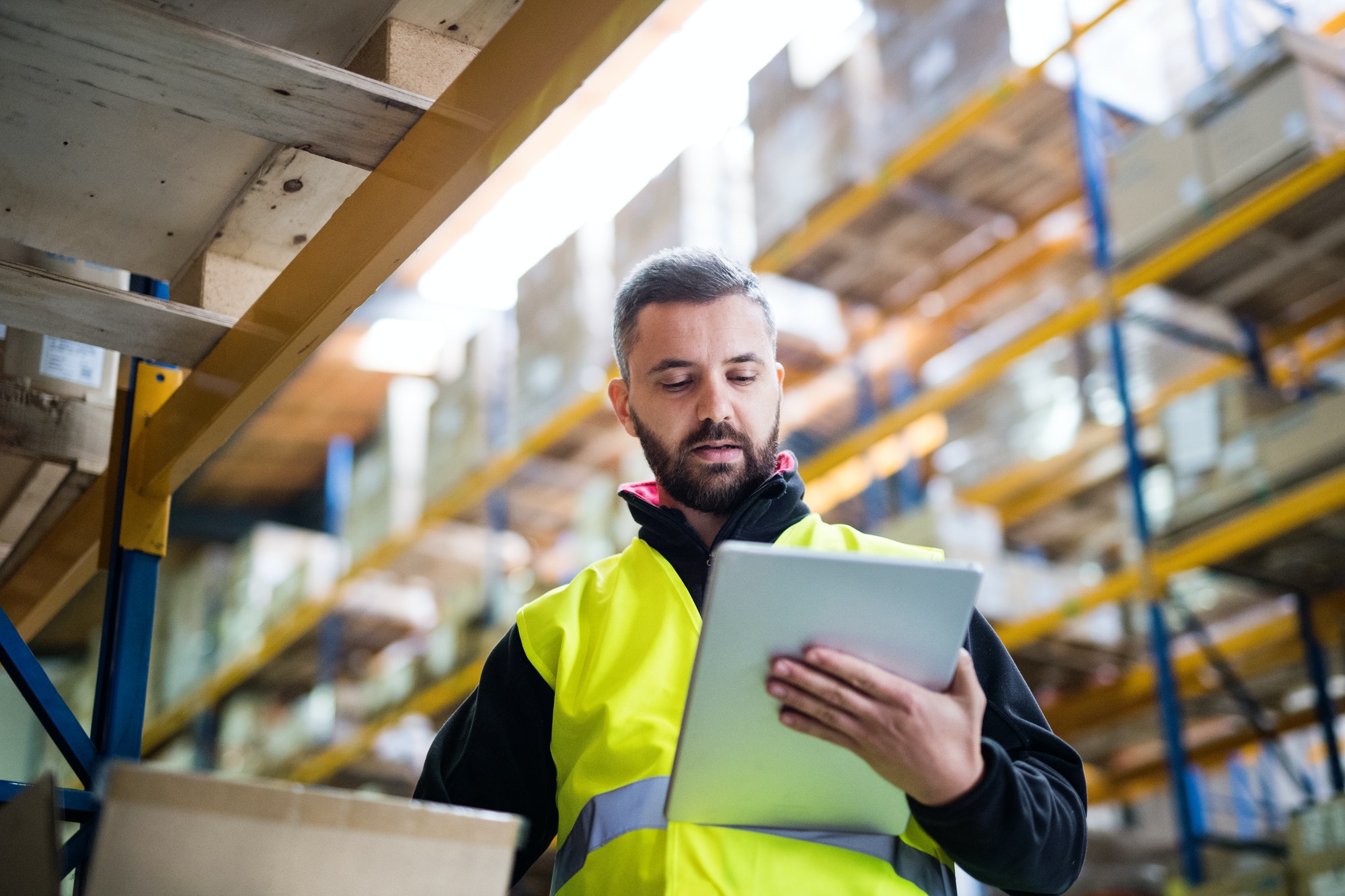 Male warehouse worker with tablet.